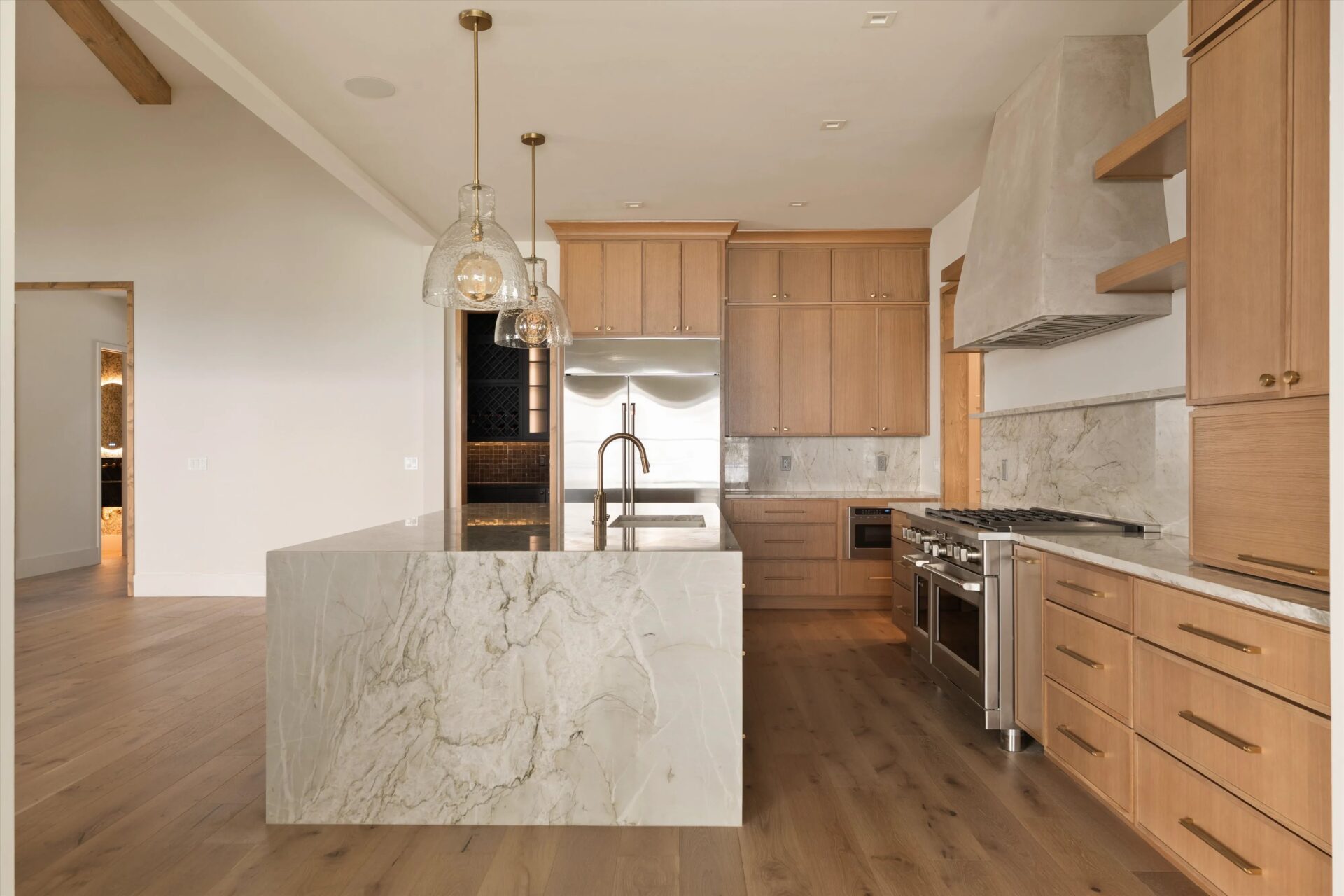 Kitchen with wood cabinets and a marble waterfall island