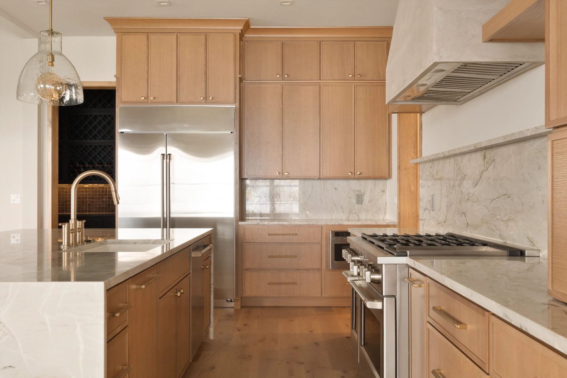 Kitchen with wood cabinets, marble counters and a center island